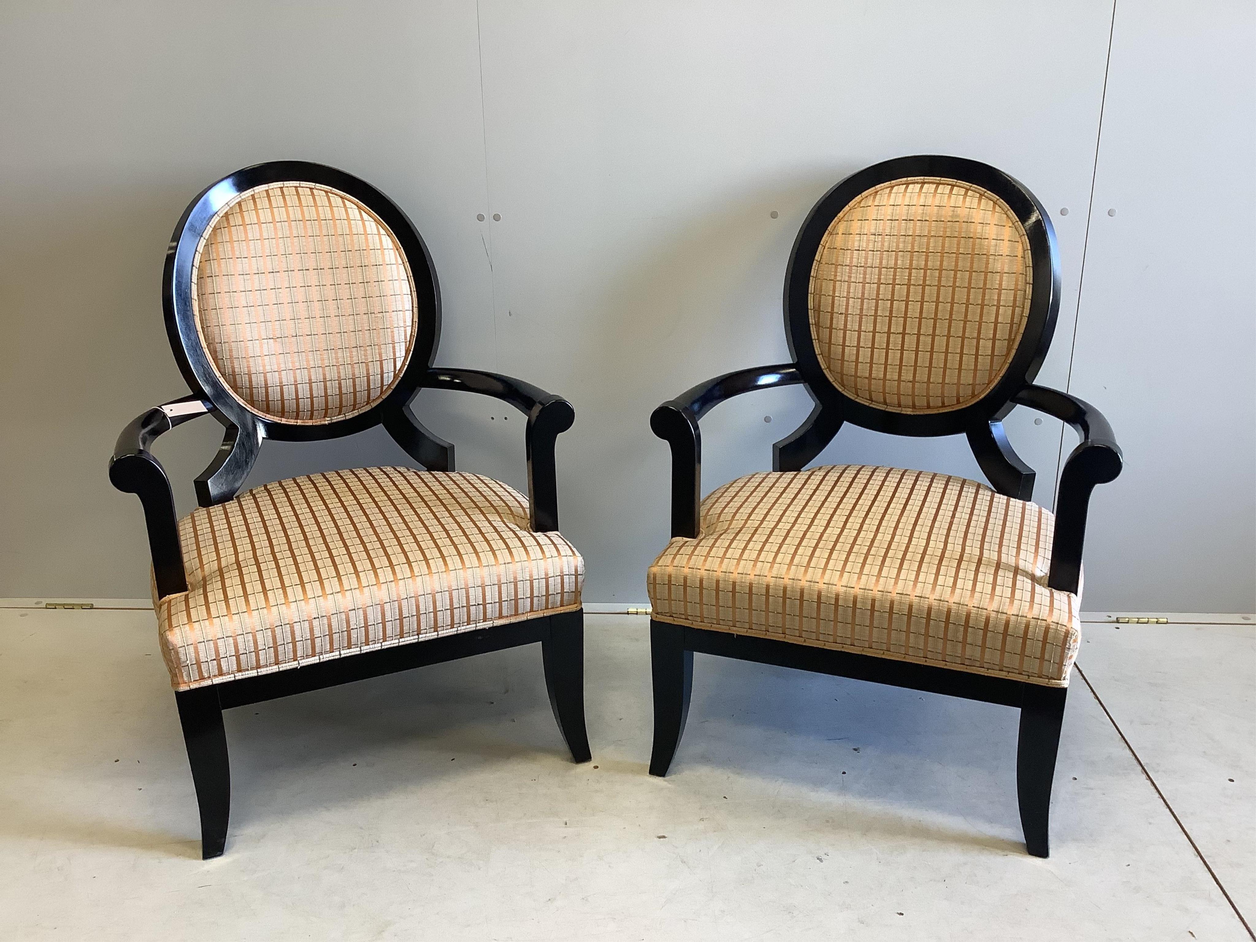 A pair of James Martin ebonised elbow chairs, width 74cm, depth 60cm, height 100cm. Condition - good